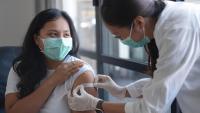 Doctor putting bandaid on a patient